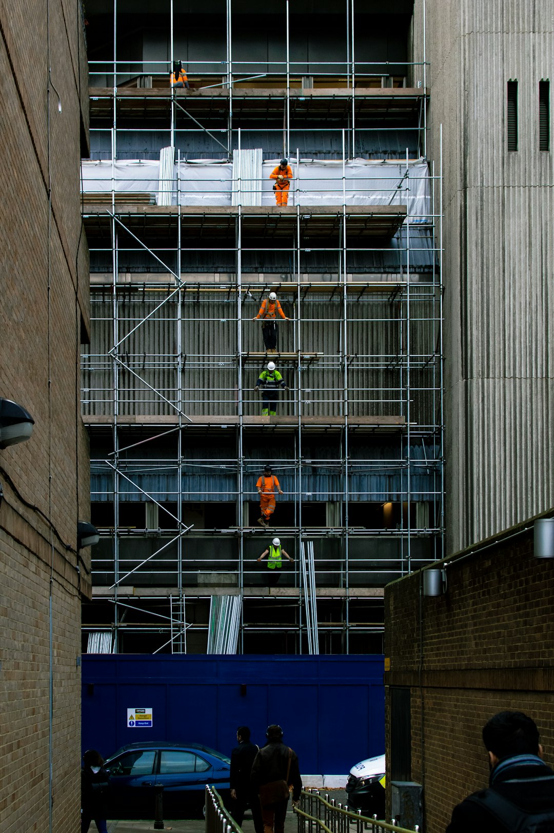 I noticed this amazing lineup of builders on my way into work recently. I fell in love with the arrangement of them and loved the contrast of their hi-vis equipment against the background.