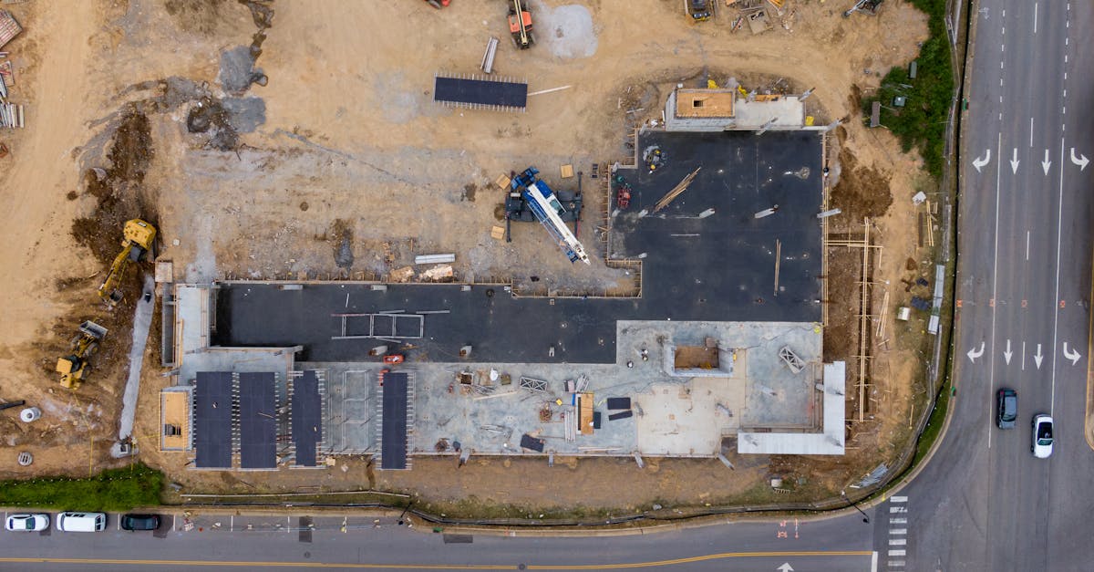 Aerial view of an active construction site with machinery and vehicles.